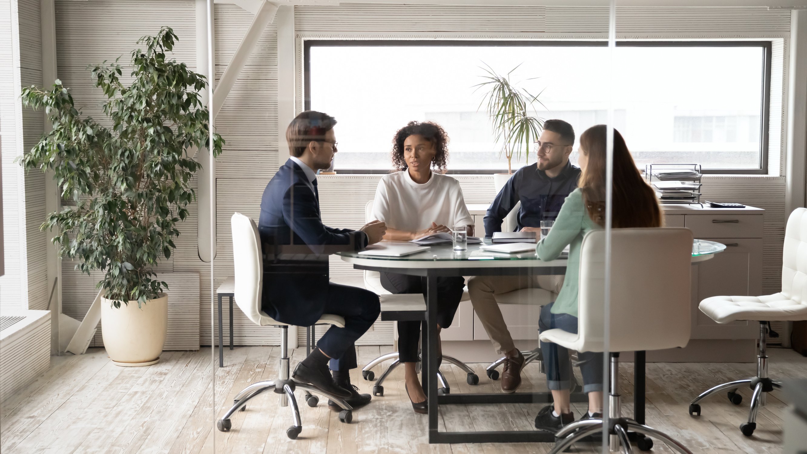 Diverse colleagues brainstorm at office team meeting